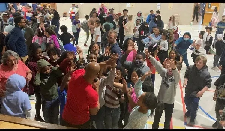 A gym full of cheering kids and coaches at a Champion Builders event